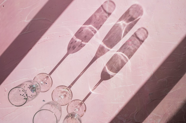 Free photo shadows made from glasses on table