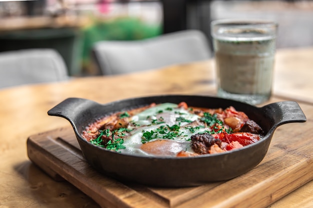 Shakshuka in a frying pan and a glass of ayran healthy and tasty food