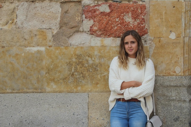 Free photo shallow focus shot of an attractive blonde hair female in a white sweater posing at camera