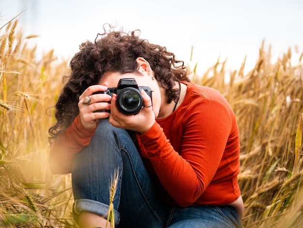 Free Photo shallow focus shot of a beautiful young female taking a photo with her camera