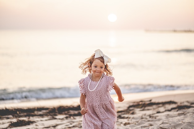 Shallow focus shot of a small blonde girl on the beach