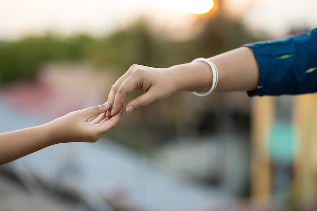 Free photo shallow focus shot of two hands touching each other gently