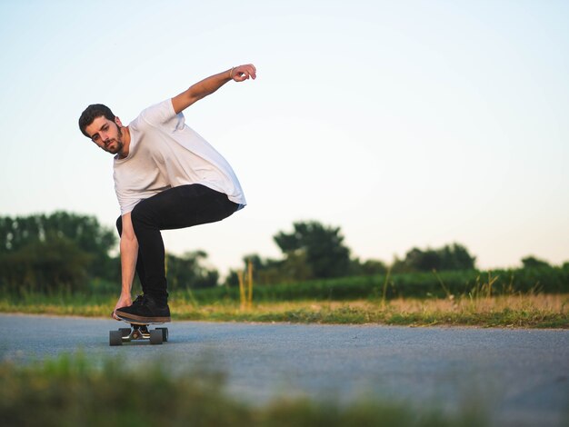 Shallow focus shot of a young handsome male riding a skateboard