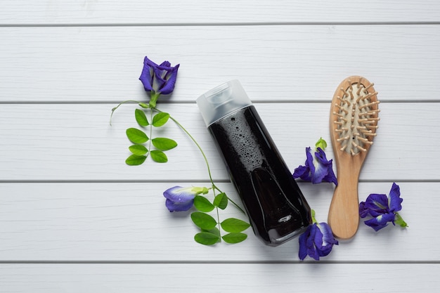 Free Photo shampoo bottle of butterfly pea flower put on white wooden background