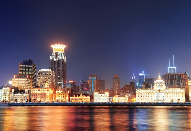 Shanghai historic architecture at night lit by lights over Huangpu River