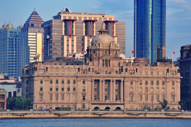 Shanghai historic and urban buildings over Huangpu River in the morning with blue sky.