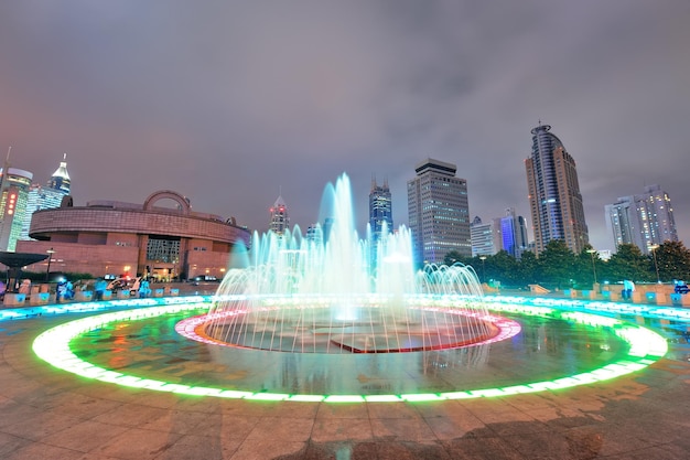 Shanghai People's Square with fountain and urban skyline at night