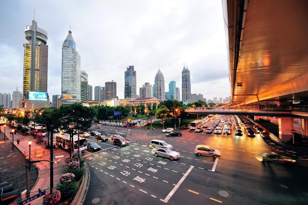 Shanghai street view with urban scene and busy traffic at dusk.