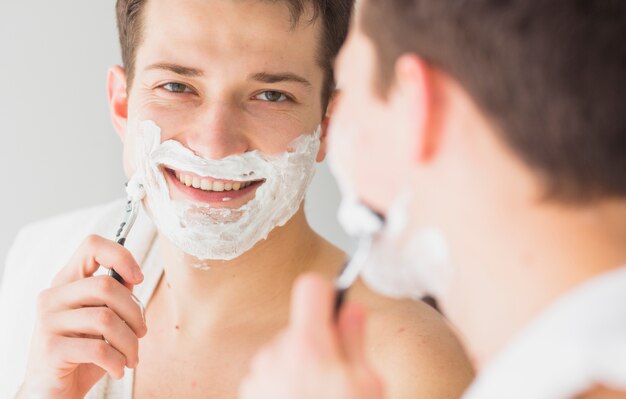 Shaving concept with attractive young man