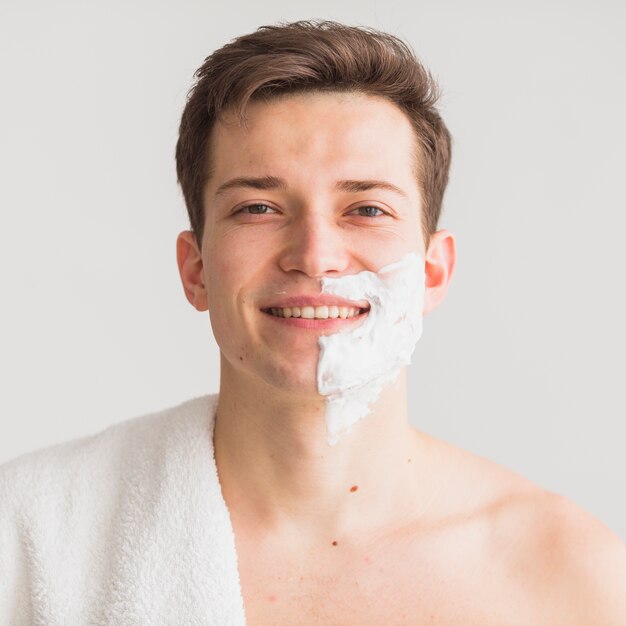 Shaving concept with attractive young man