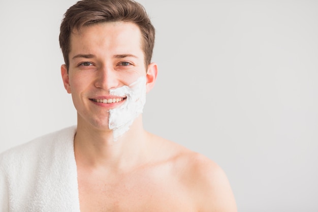 Shaving concept with attractive young man