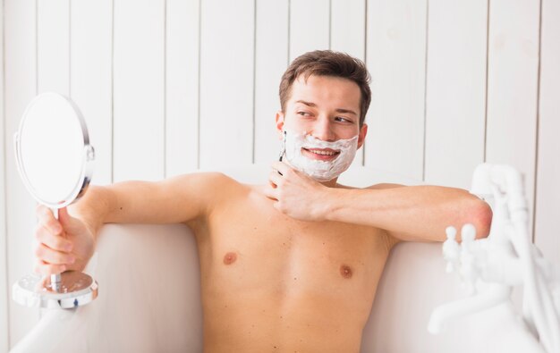 Shaving concept with attractive young man