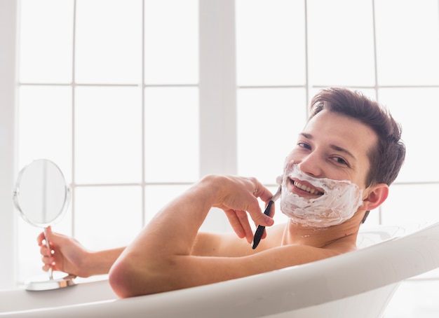 Shaving concept with attractive young man