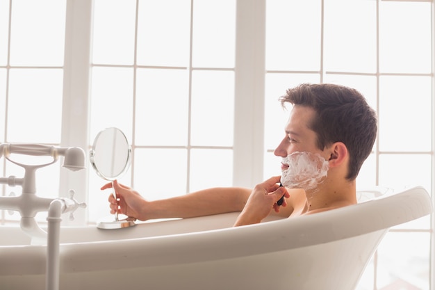 Shaving concept with attractive young man