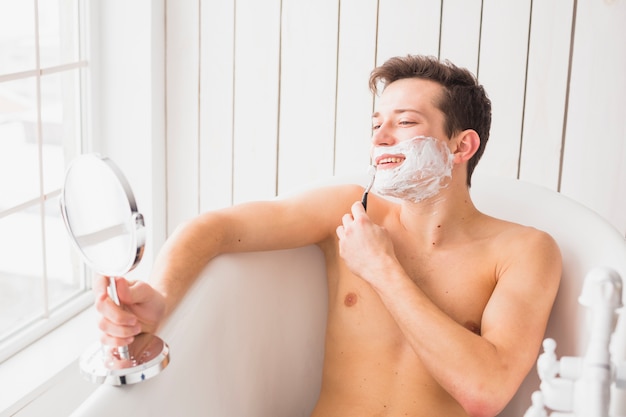 Shaving concept with attractive young man