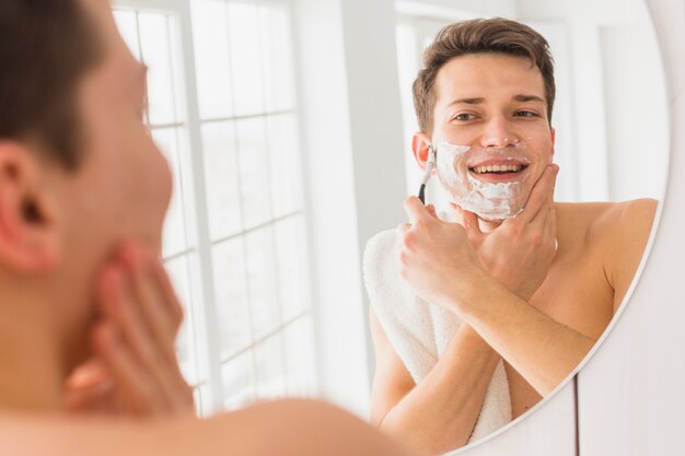 Shaving concept with attractive young man