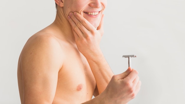 Shaving concept with attractive young man