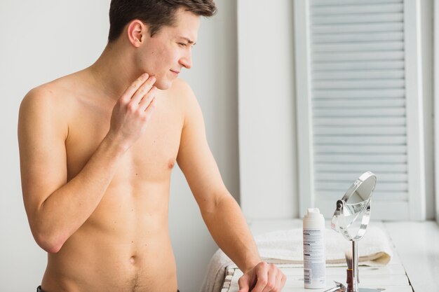 Shaving concept with attractive young man