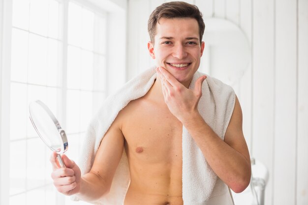 Shaving concept with attractive young man