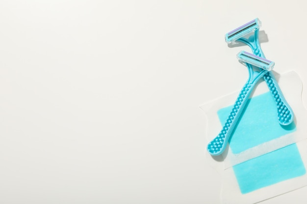 Free photo shaving razors with wax strips on a light background