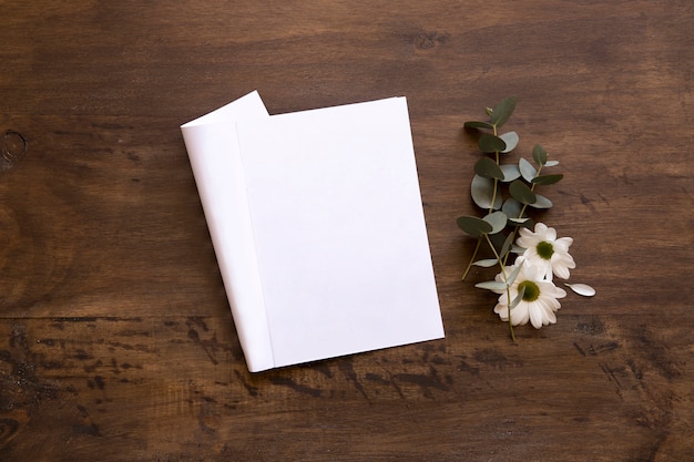 Free photo sheet mockup next to flowers