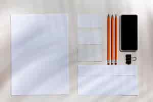 Free photo sheets, gadgets and work tools on a white table indoors.