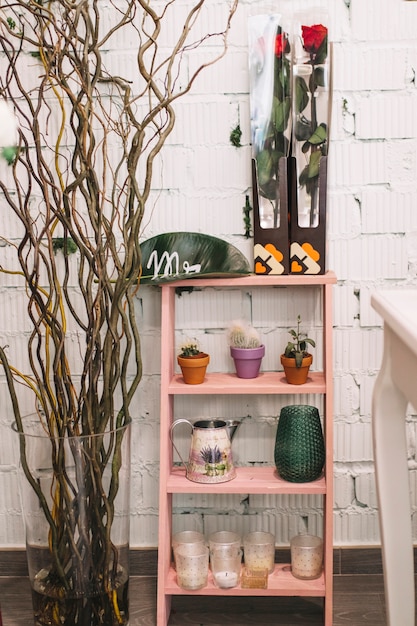 Free photo shelf with pots and flowers