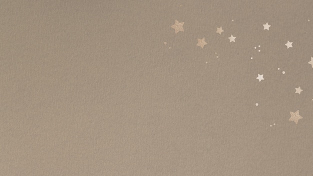 Free Photo shimmering gold stars on a beige background