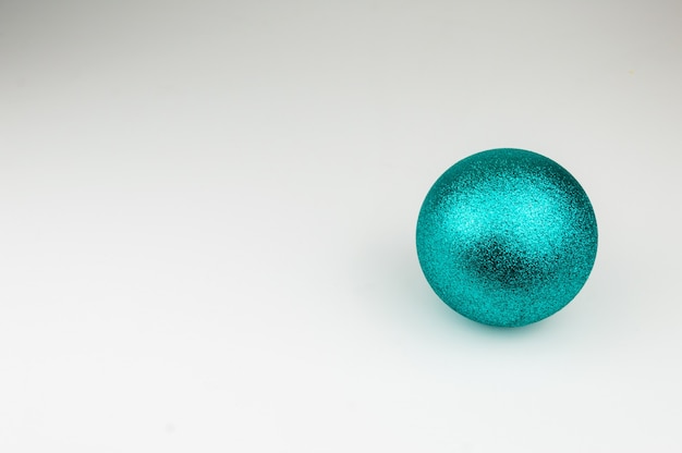 Free photo shiny blue christmas ball on white