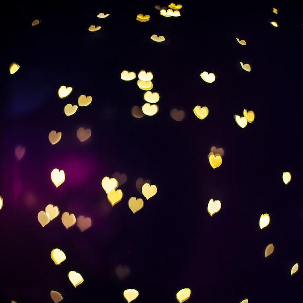 Shiny hearts on dark background