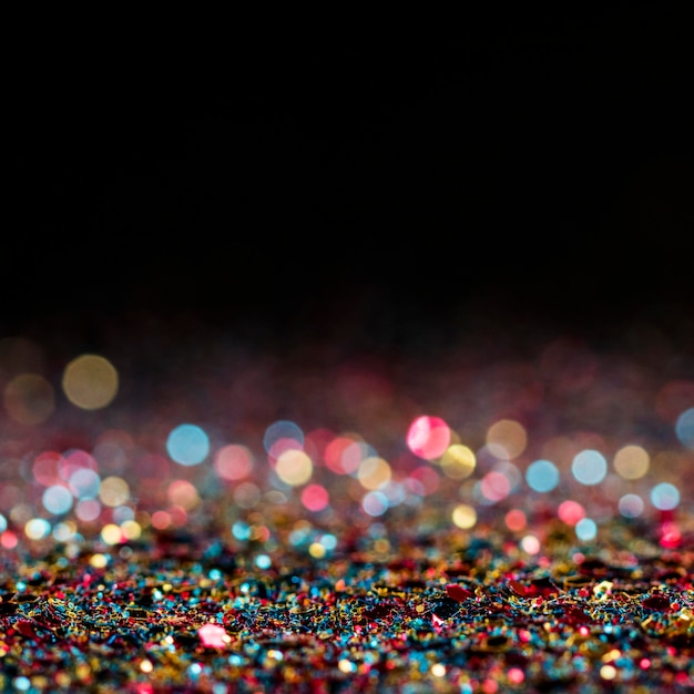 Free photo shiny multicolored glitter with copy space