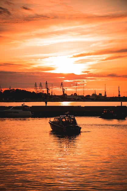 Free Photo ship on the sea with the beautiful sunset reflecting on the surface