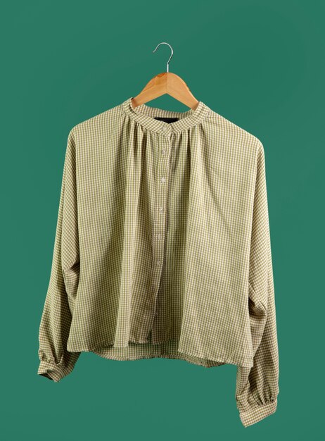 Shirt on hanger with green background