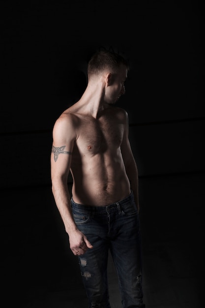 Shirtless man in jeans