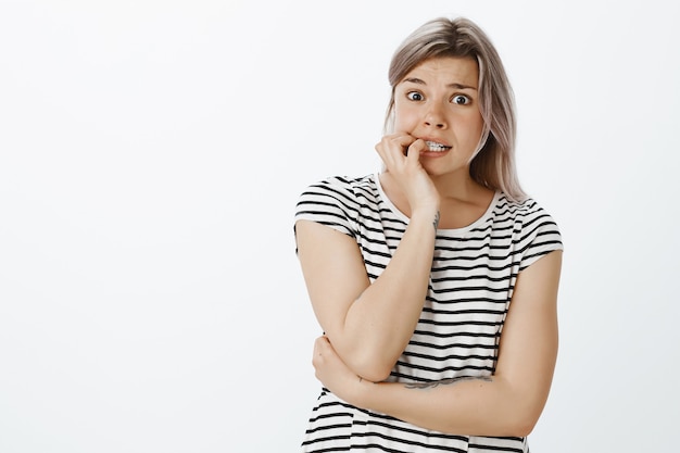 Shocked blonde girl posing in the studio