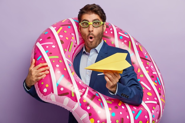 Shocked businessman posing in classy suit at the office