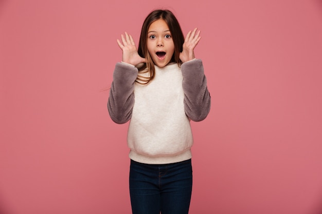 Shocked happy girl in casual clothes looking with opened mouth isolated