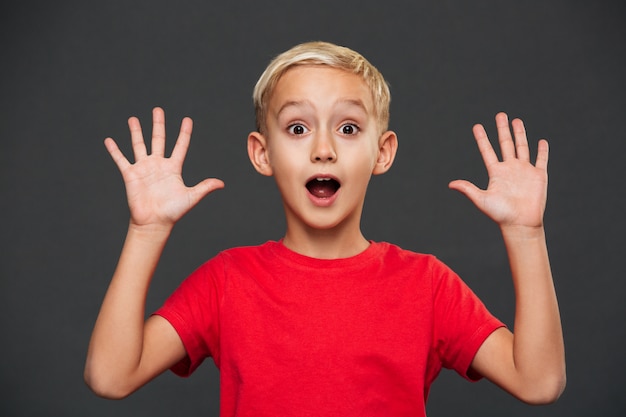 Free photo shocked little boy child standing isolated