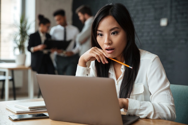 Shocked young asian businesswoman