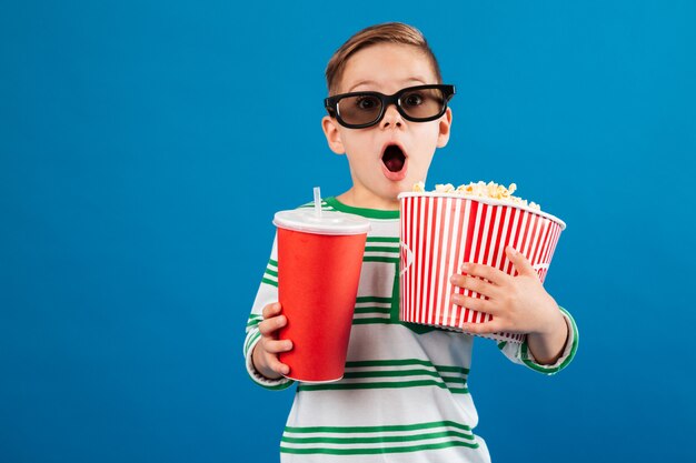 Shocked young boy in eyeglasses preparing to watch the film