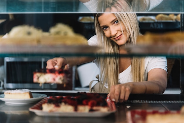 Shop assistant holding pastry