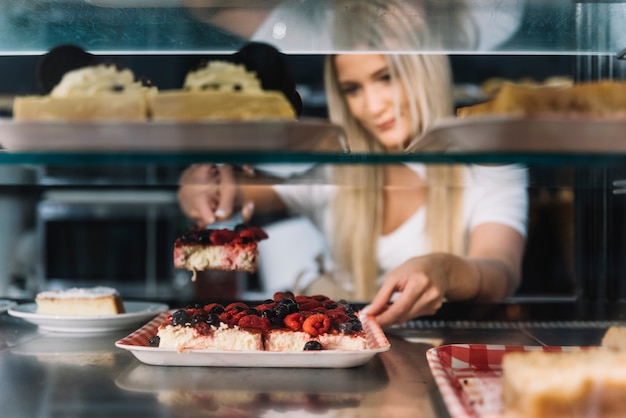 Shop assistant holding pastry