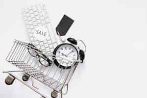 Free photo shopping cart with objects and sale sticker