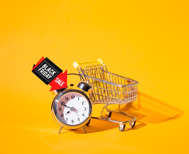 Free Photo shopping trolley near alarm clock