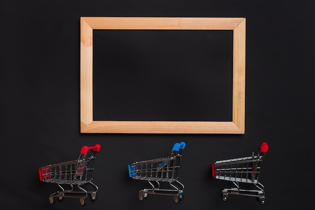 Free photo shopping trolleys with red and blue handles and photo frame