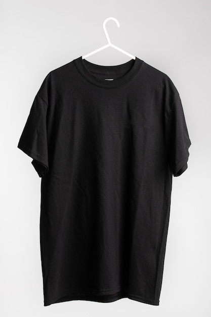 Short sleeve shirt on cloth hanger with white wall in the background