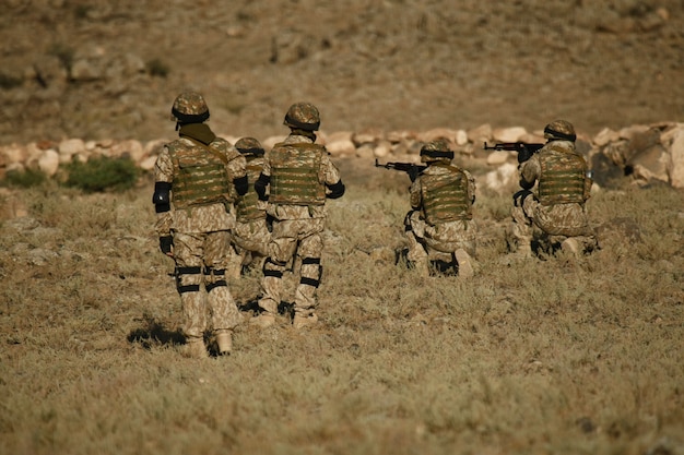 Free photo shot of armenian military soldiers training in a dry field