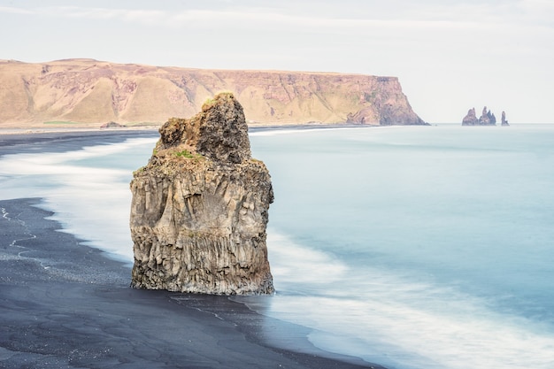 Shot of a big rock in a sea, Reynisfjara Beach in Vik, Iceland