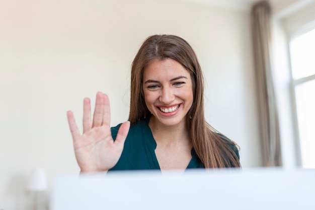 Free Photo shot of a businesswoman on a video call while sitting at her deskcropped shot of an attractive young woman using her laptop to make a video call at home