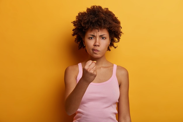 Shot of displeased dark-skinned woman has serious look